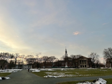 Baker Tower from the Dartmouth Green, with some snow left on the ground, at sunset