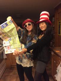 Colleen and a friend dressed in flair pretending to look at a map 