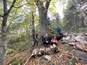 Kalina and her friends posing by an old-growth tree