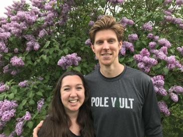 Colleen and her friend Matt in front of a flowering tree in the spring