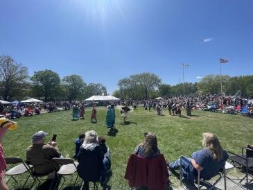 An image taken on a sunny day just outside the center circle powwow dancing arena on the green—Dartmouth's 51st annual powwow