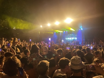 A dimly lit image of the main center stage at Dartmouth's large concert during Green Key Weekend on Tuck Drive featuring Neon Trees