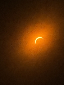 The sun through eclipse glasses during near entire coverage
