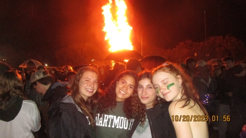 Friends standing in front of the homecoming bonfire