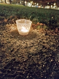 a Candle at Diwali which casts a warm glow on the ground around it