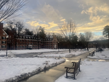 A picture of a snowy/slushy evening amidst a sunset on Tuck Drive at Dartmouth College