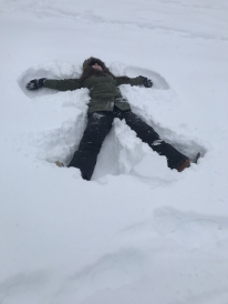 Colleen making a snow angel on the golf course