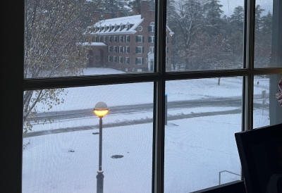 An image of snow on the ground outside a window