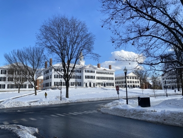 Image of a snowy dartmouth hall in front of a deep blue sky