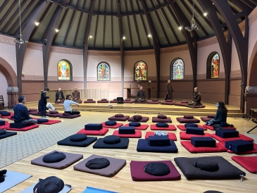 Meditation cushions in front of a stage in Rollins Chapel