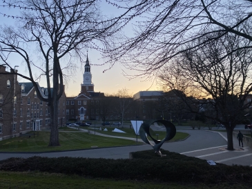 a picture of the sunset behind baker berry in front of wilder, home of the physics department
