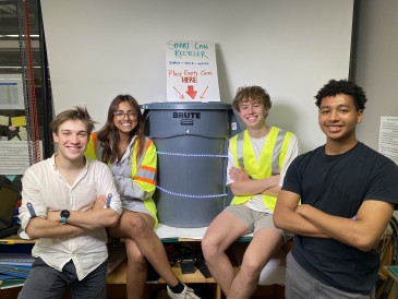 a picture of martin and his engineering team with an advanced trash can between them, their engineering project!