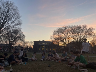 Students sitting on the Green in a semi-circle