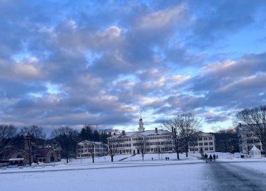Dartmouth Hall, a white brick building on Dartmouth College's campus, in the snow