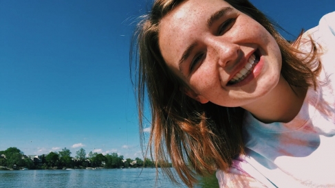 Abbi taking a selfie with a river in the background