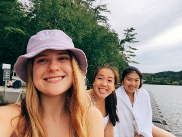 Jenny posing with two friends on the dock