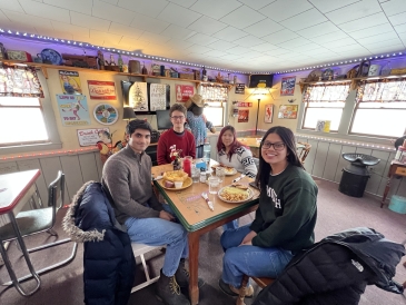 Diana '23, Peter '23, Michelle '23, and Varun '23 eating breakfast at local diner