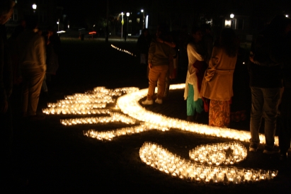 diwali candles on in the dark on the green