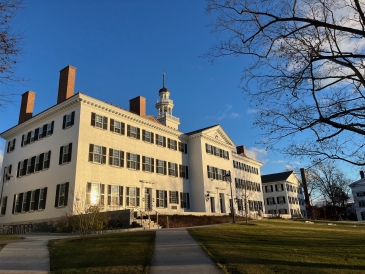 A photo of Dartmouth Hall at golden hour with blue skies.