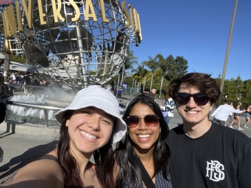 An image of three students in front of the Universal Studios sign.