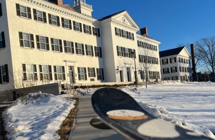 A photo of Dartmouth Hall with my ski tips in the foreground. My skis are out of focus, whereas Dartmouth Hall is in focus.
