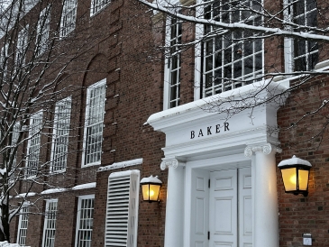 A photo of the snowy east entrance of Baker-Berry library