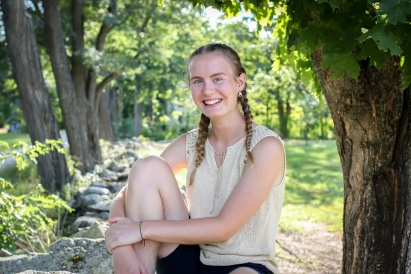 A picture of Lily in the woods of her hometown