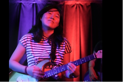 Olivia Koo playing guitar