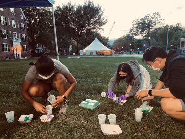 Attempting to precisely pour dye onto minuscule masks.