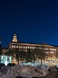 A nighttime photo of Berry Library, with the Baker Tower in the background