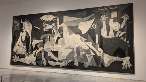 This is a picture of Guernica by Pablo Picasso which is a large artwork housed in the Museo de Reina Sofia.