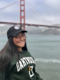 Samantha posing for a photo in a Dartmouth sweatshirt