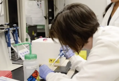 Researcher engaging with lab sample