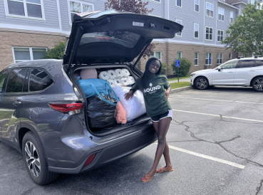 Chelsea in front of a packed car