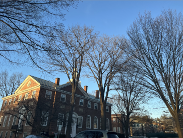 A brick building with blue skies and trees