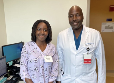 A picture of me standing with the General Surgeon that I shadowed.
