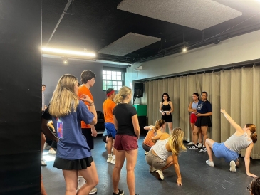 Students listening to dance instruction in Sarner Underground