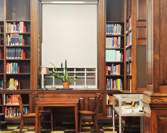 Library with window in middle, with bookshelves surrounding it 