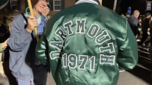 a man wearing a jacket that says "Dartmouth 1971"
