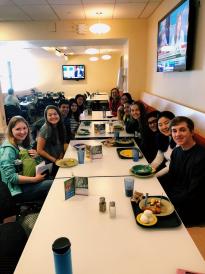 group of students at long table in dining hall