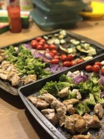 Rainbow vegetables and chicken on cookie sheet. 