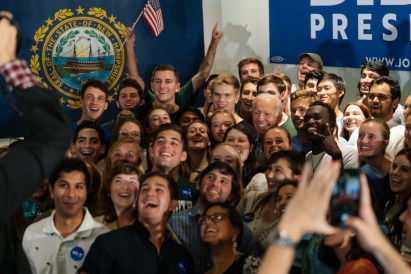 President Joe Biden surrounded by a crowd of Dartmouth students, all smiling