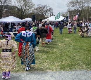 Parade of Native people dressed in regalia as they march out into arena for Dartmouth annual powwow's grand entry.