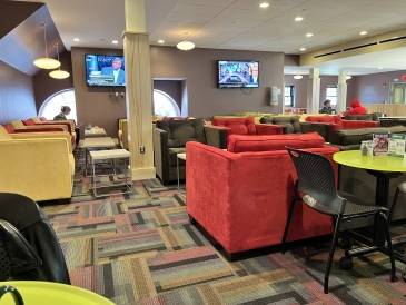 Picture of a dining hall room filled with small, colorful armchairs