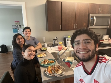 An image of students eating a meal in an apartment
