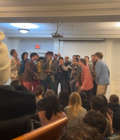 The Dartmouth Aires performing a song in one of the frat houses. 
