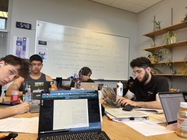 An image of a group of students studying at a table in the library