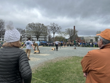 Dartmouth's Timber Team participating in a wood chopping relay on the Green