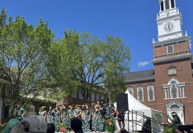 An image of the stage with student performers at the Lū'au, in front of the Baker Library