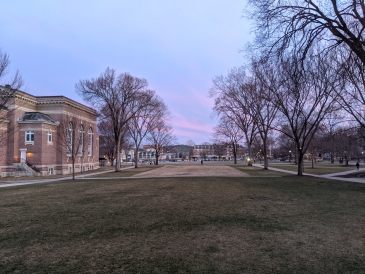 View of a pink sunset sky looking out from the Baker Berry library. 